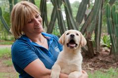 Me with a yellow Labrador puppy.