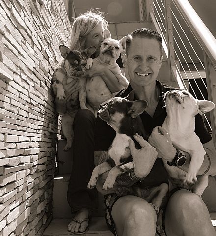 Breeders sitting on the stairs with their Frenchies.